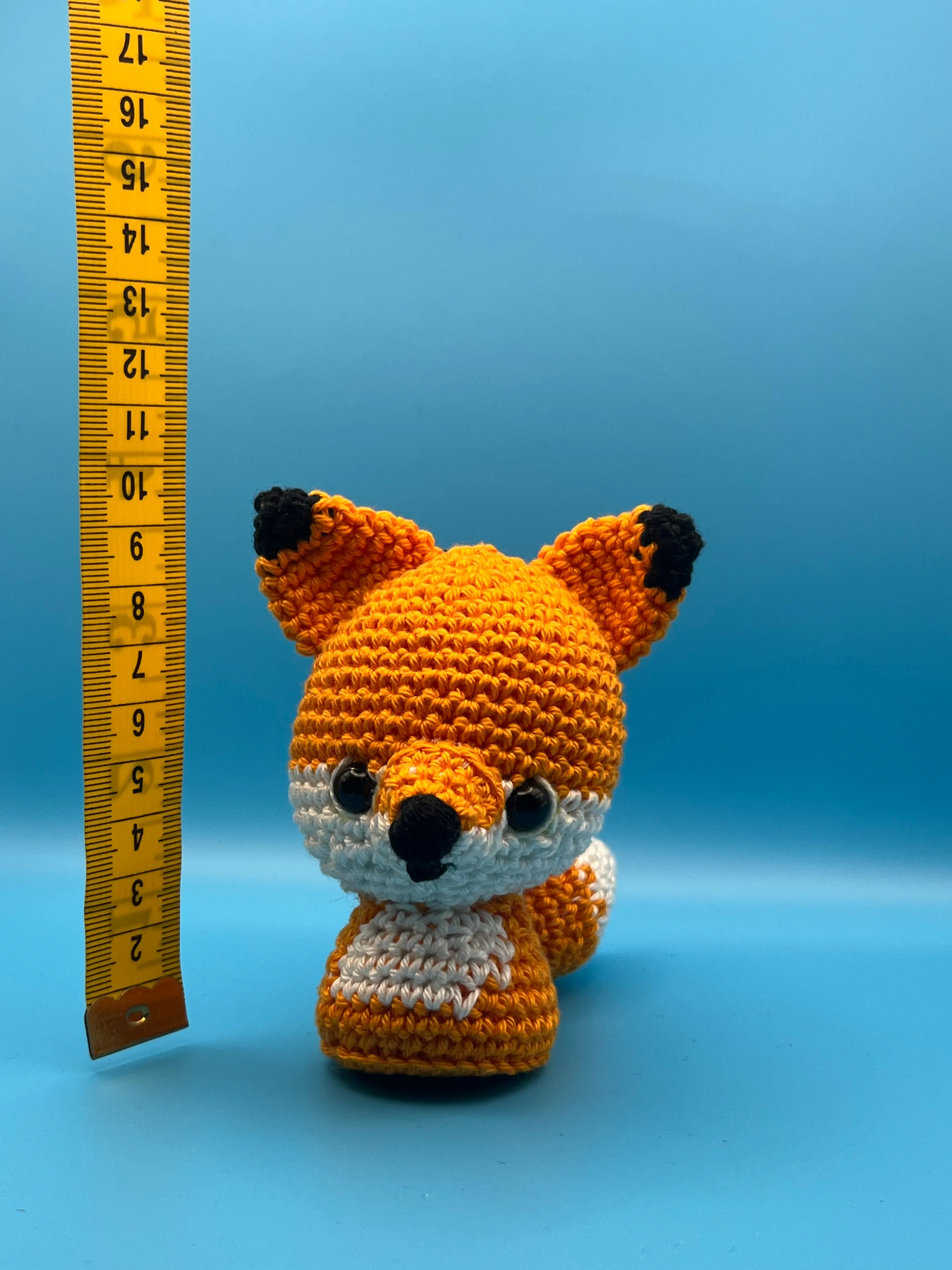 The Little Prince’s fox amigurumi photographed on a blue background