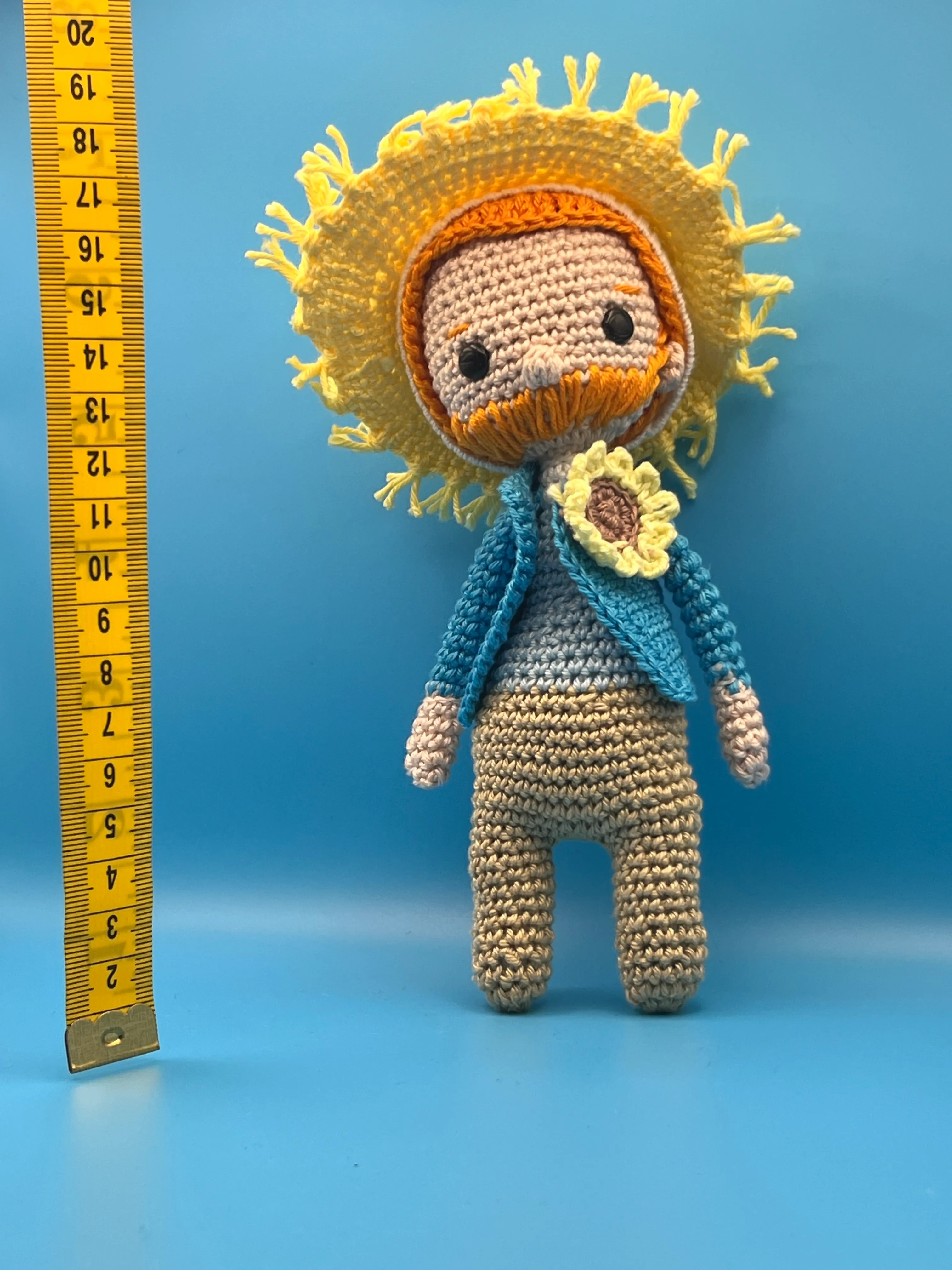 Vincent van Gogh amigurumi showing his orange yarn beard and straw hat