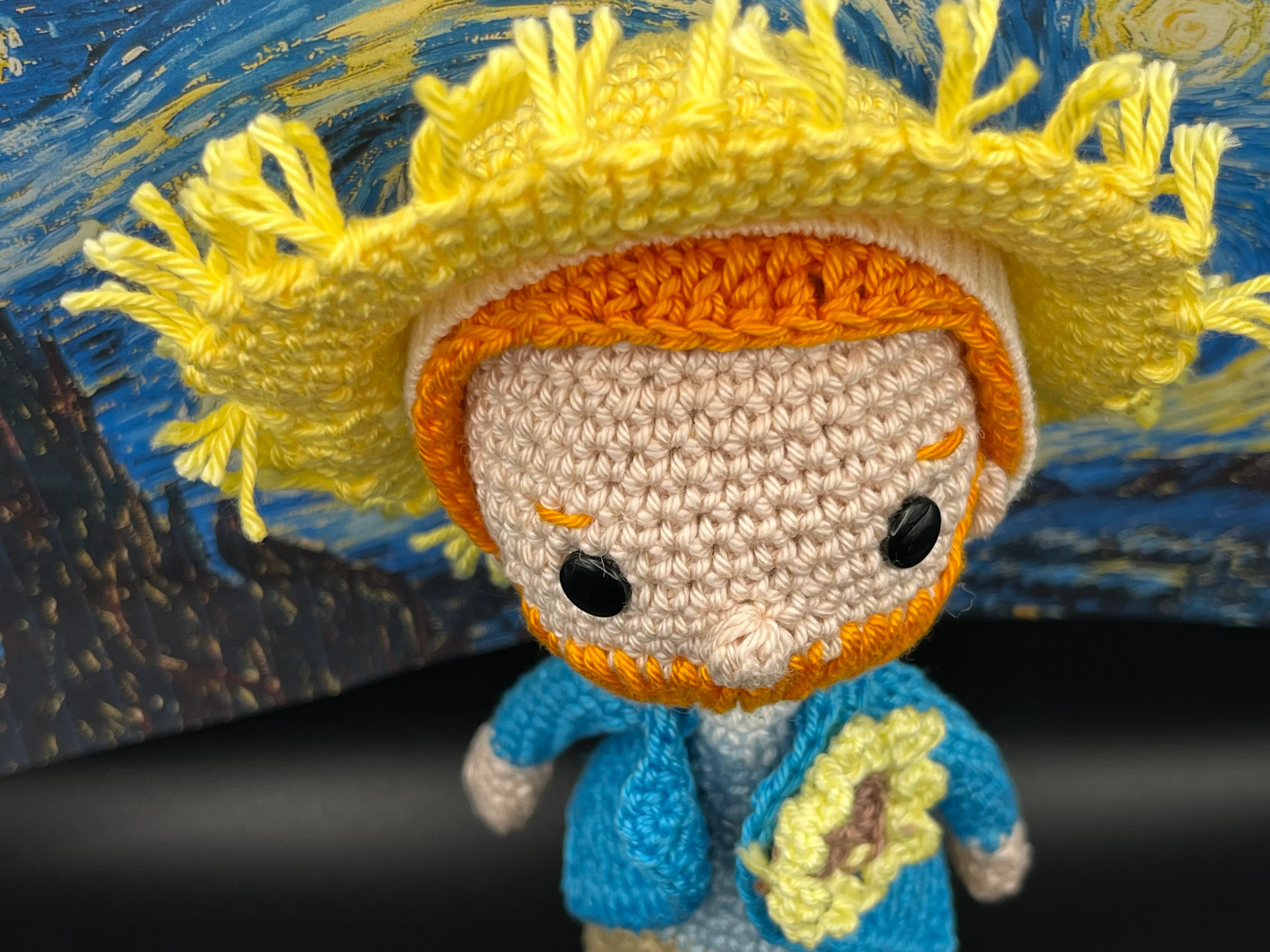 Vincent van Gogh amigurumi posed against a Starry Night inspired background