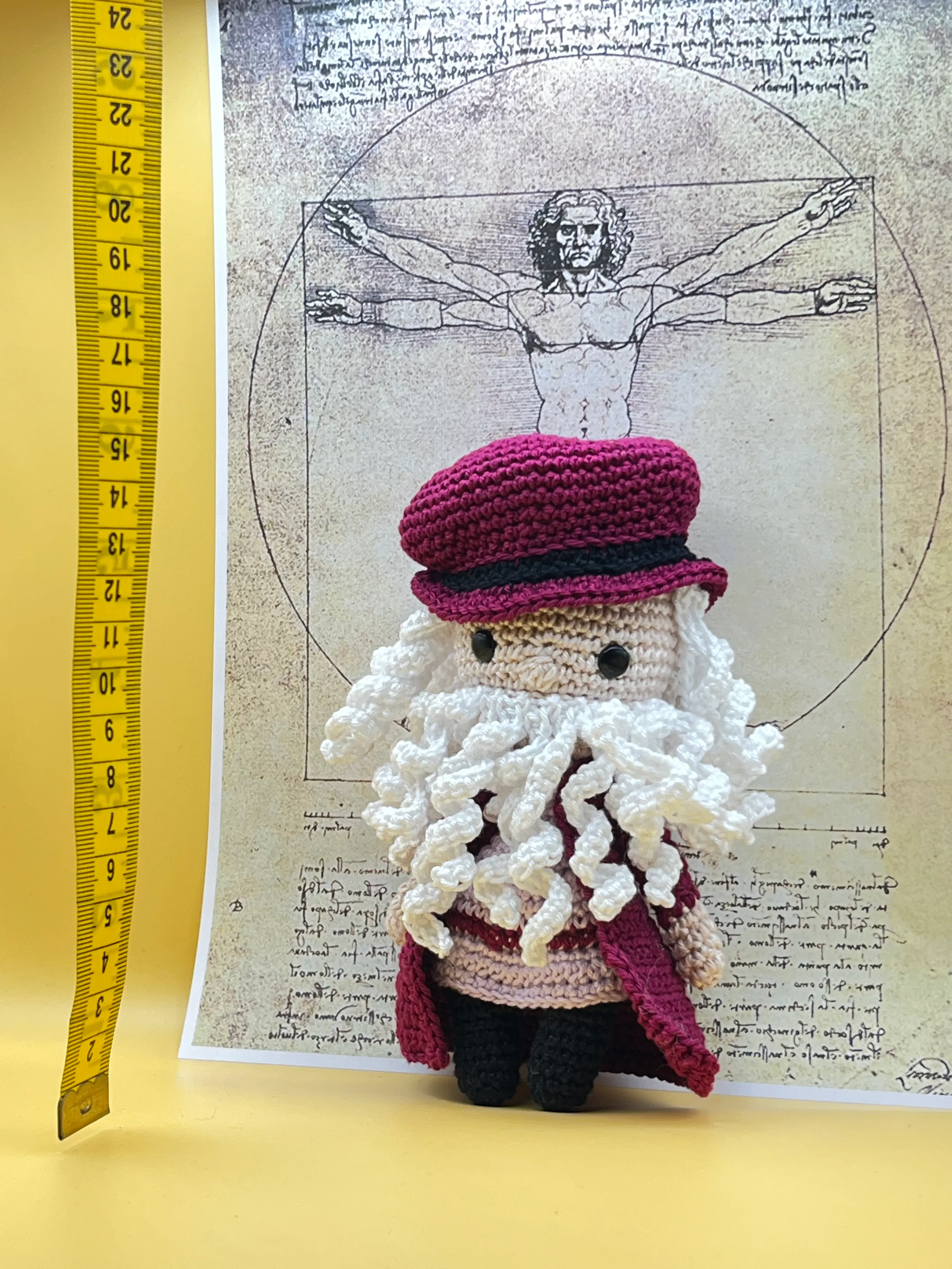 Leonardo da Vinci amigurumi posed in a Renaissance-inspired setting