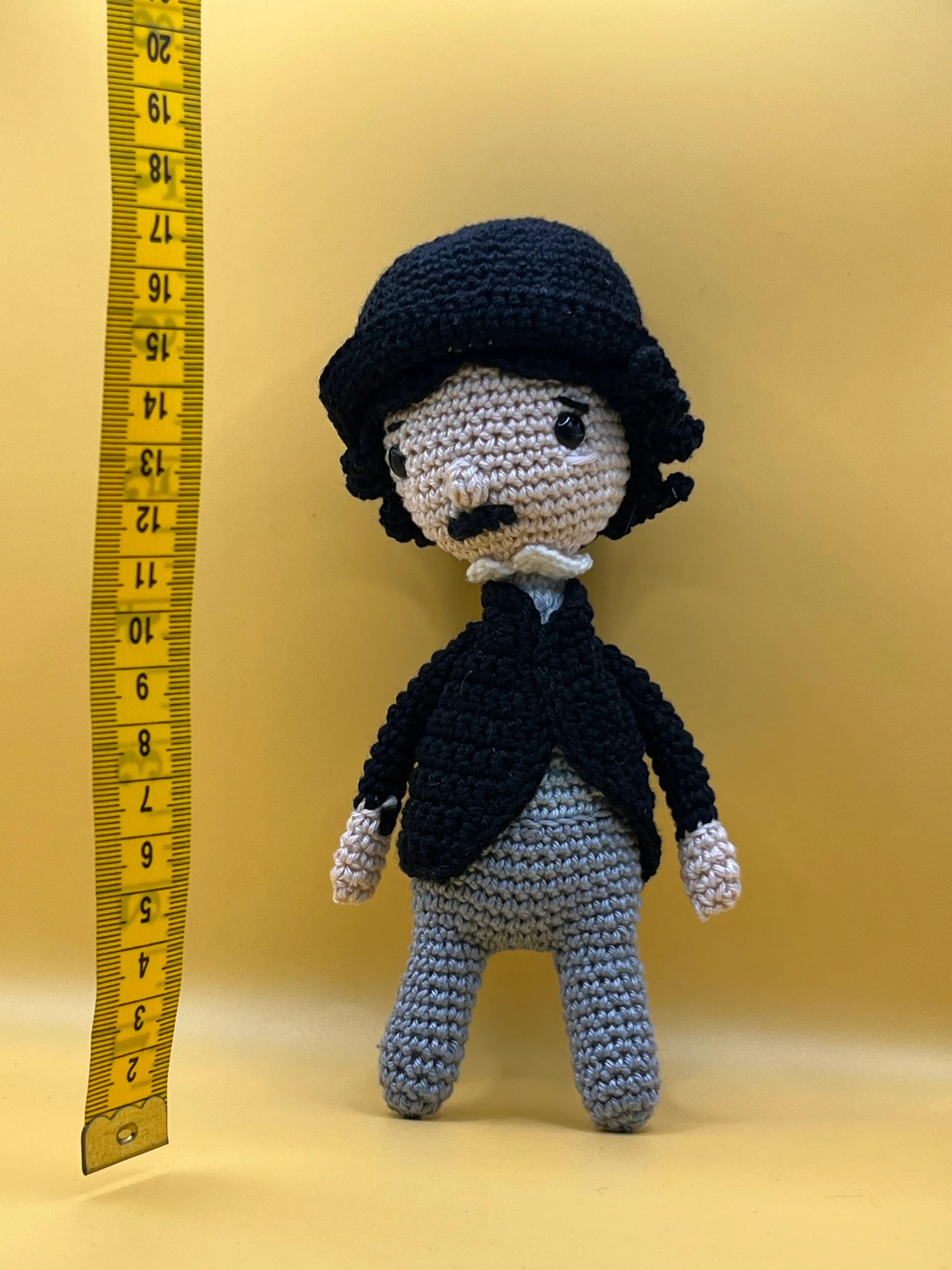 Charlie Chaplin amigurumi posed in a silent-film inspired setting