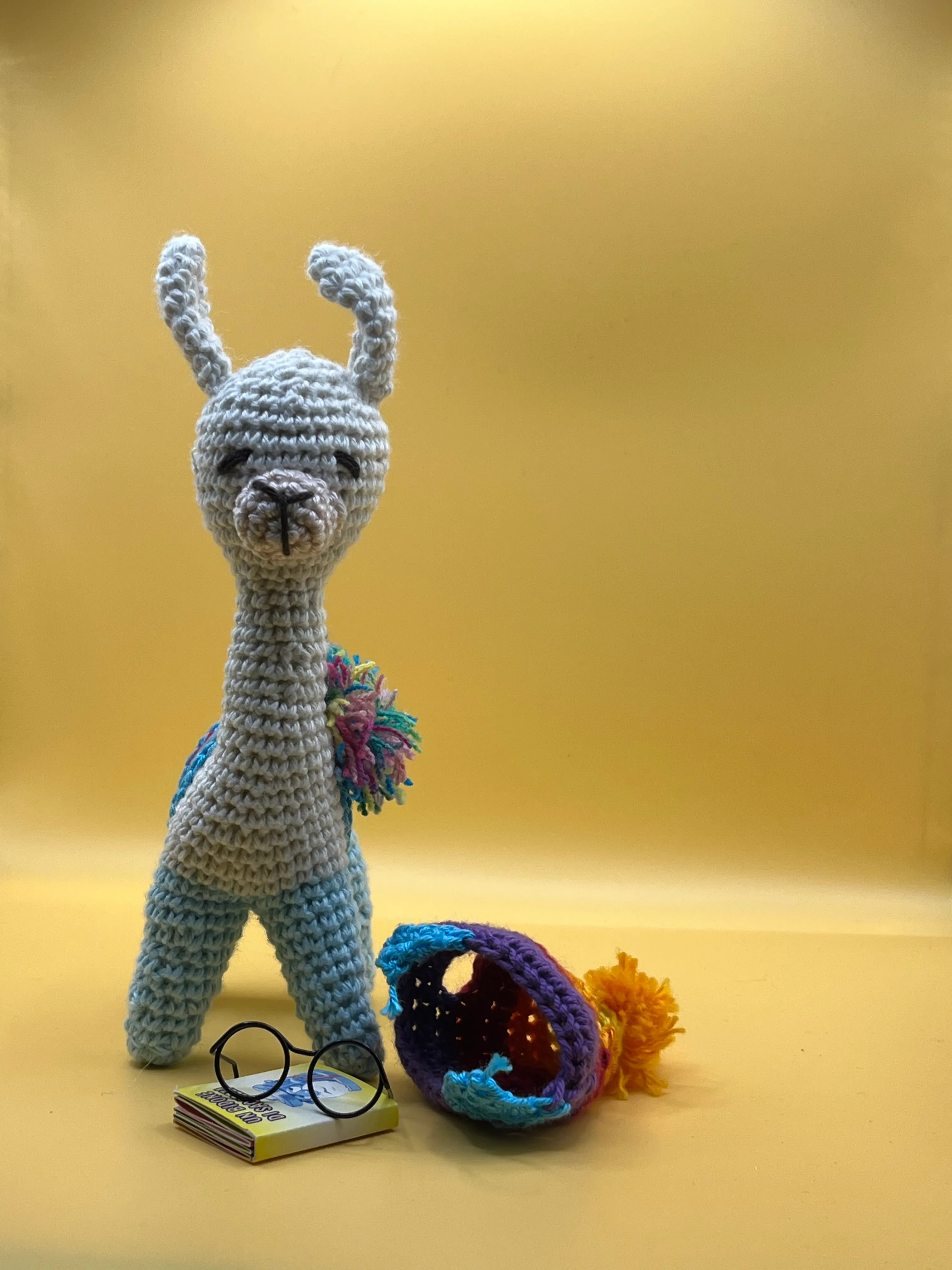 The handmade llama photographed on a warm neutral background
