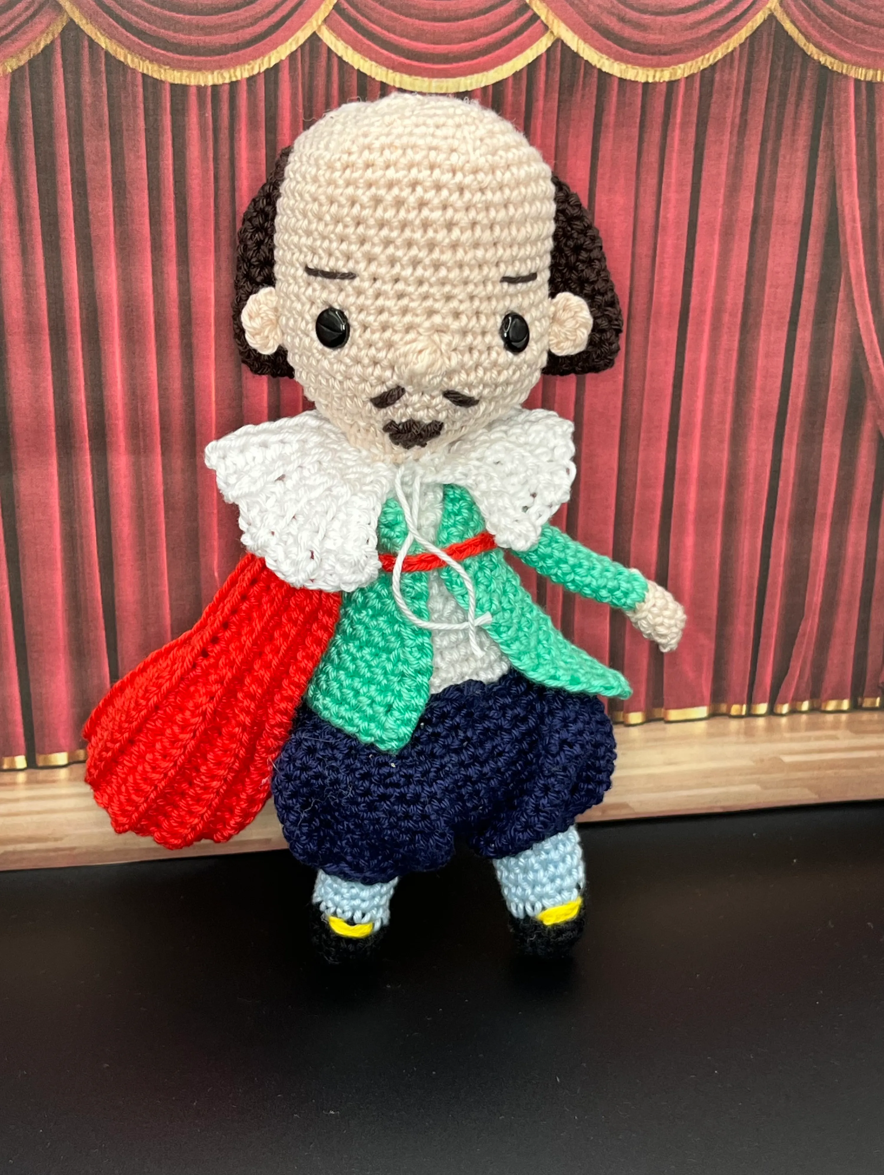 Close view of Shakespeare’s embroidered expression and clothing details