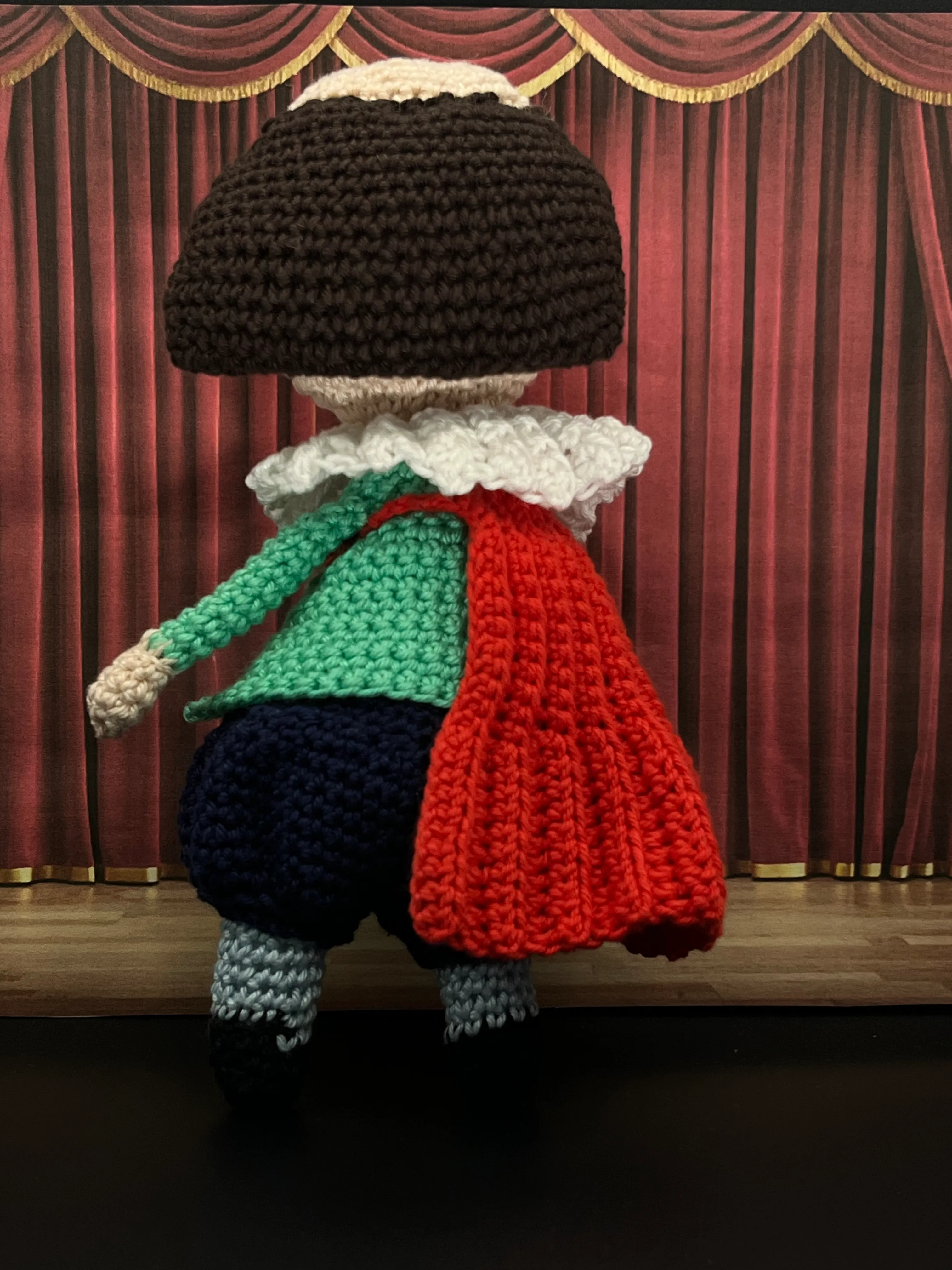 William Shakespeare amigurumi posed in a theatrical setting