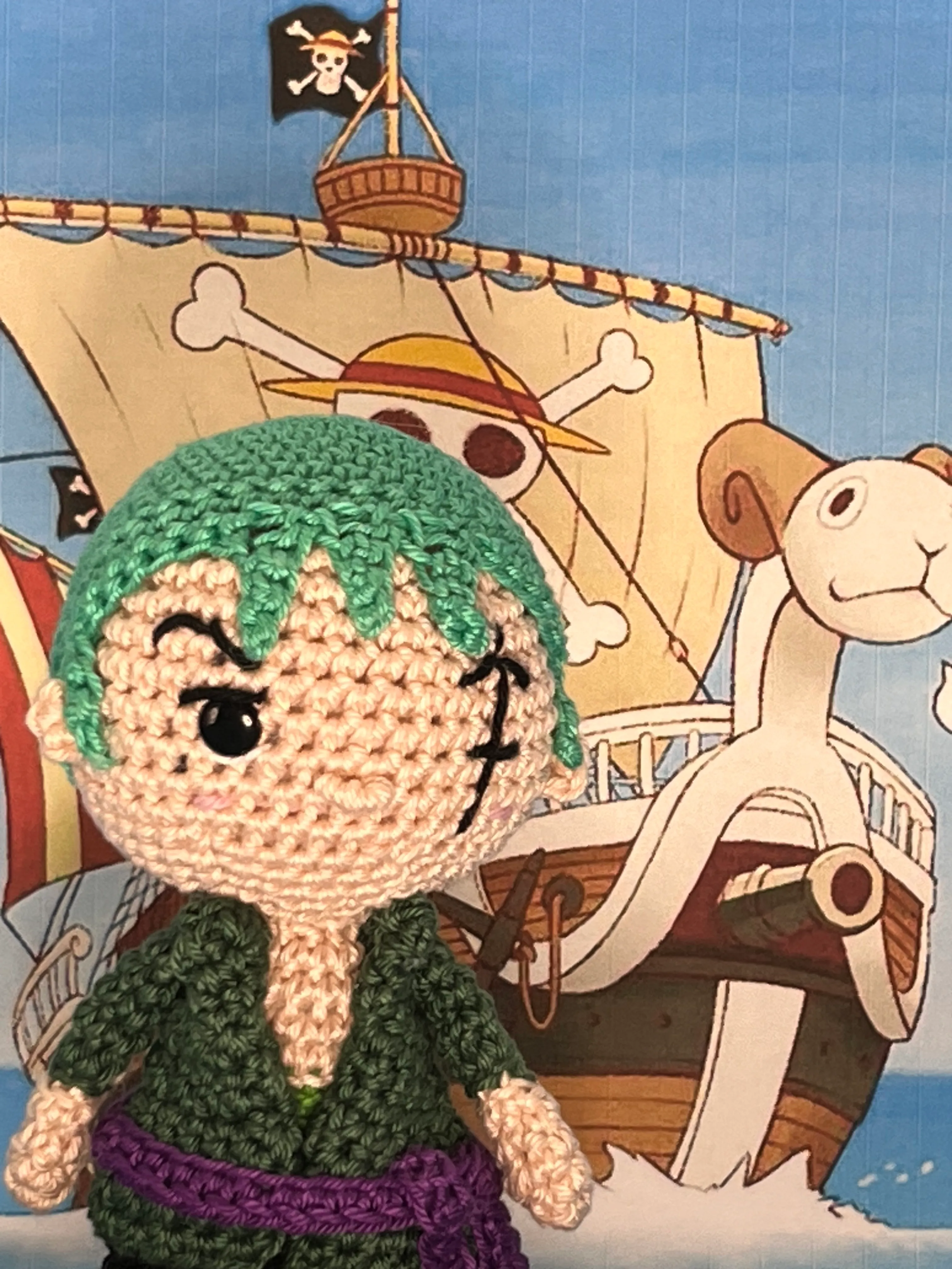 Close view of Zoro’s green crocheted hair, embroidered scar, and purple sash