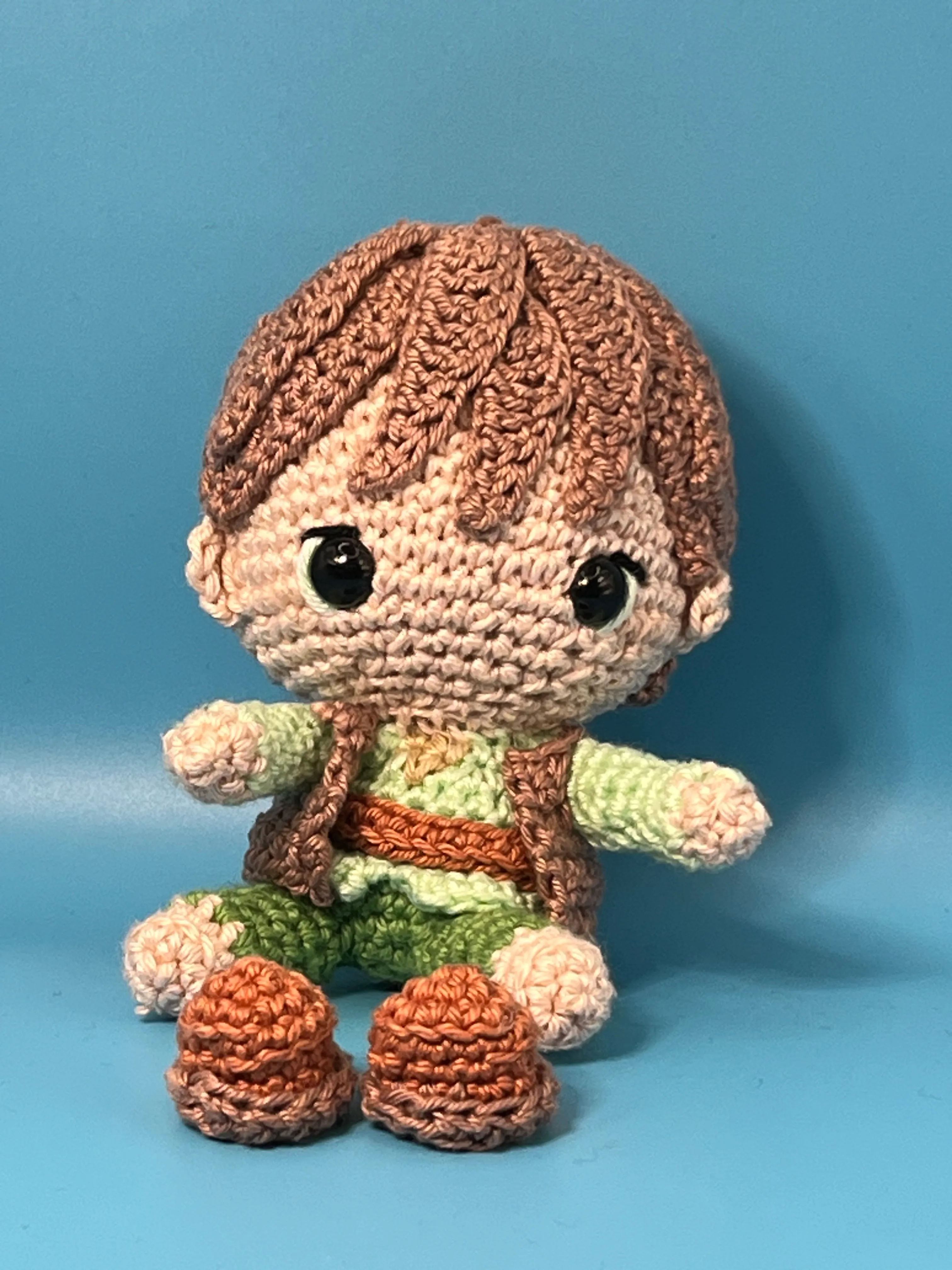 Hiccup amigurumi showing the layered green and brown costume