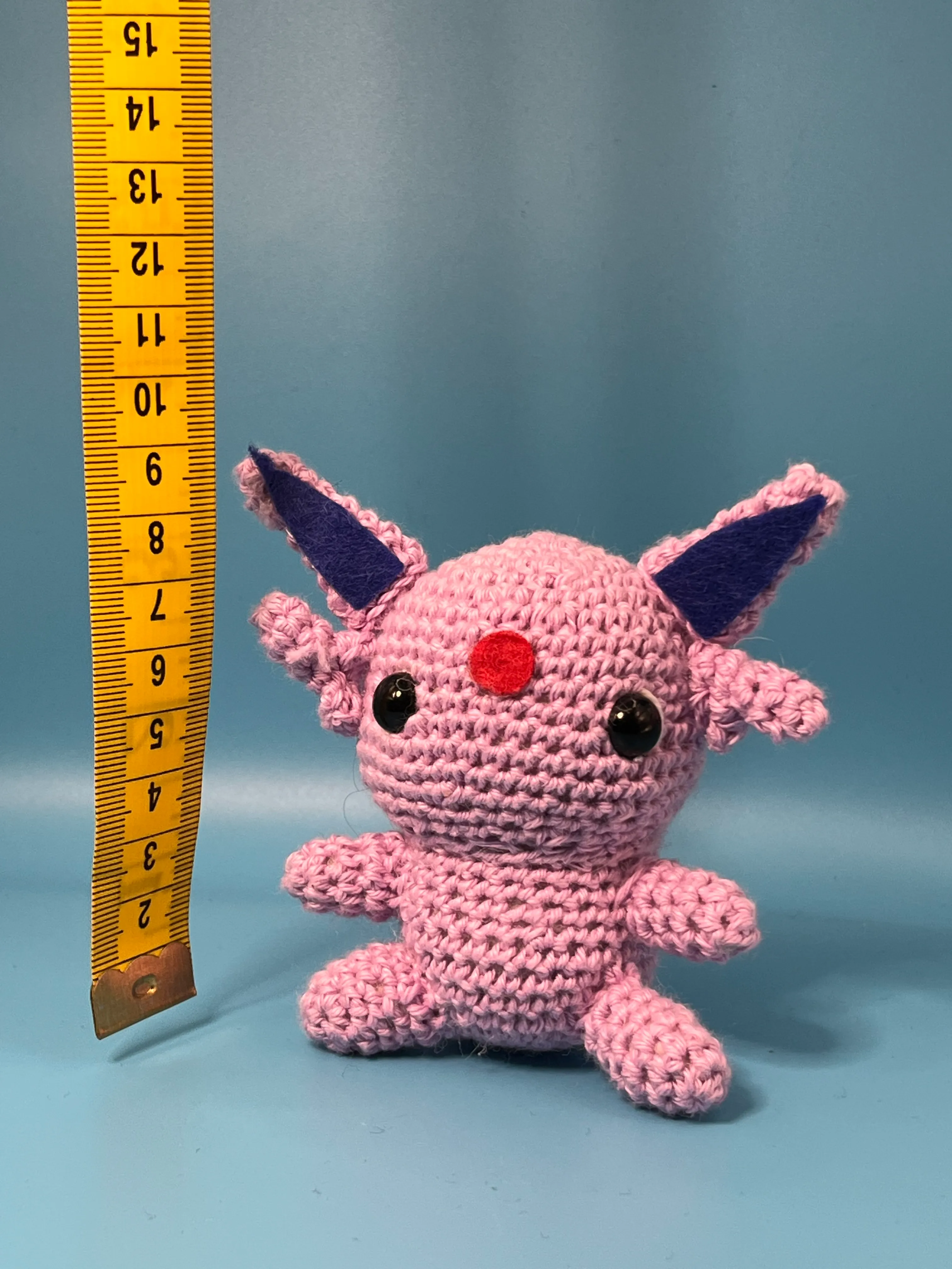 Close view of Espeon’s embroidered eyes and red forehead gem