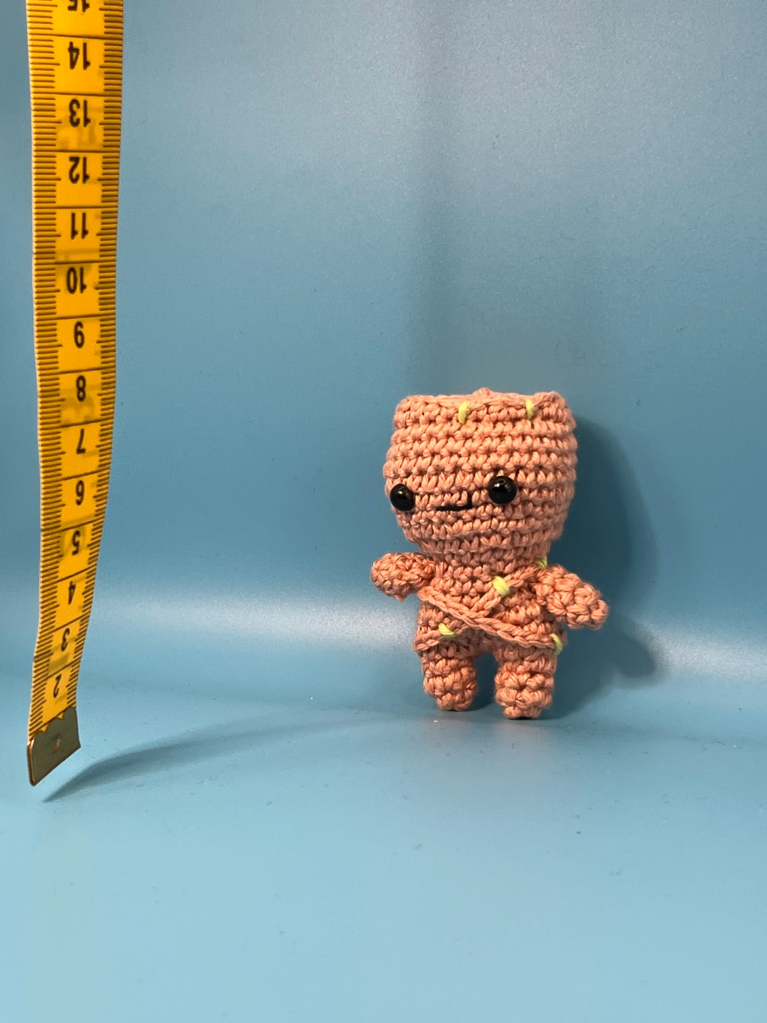 Close view of Groot’s embroidered face and branch-like head