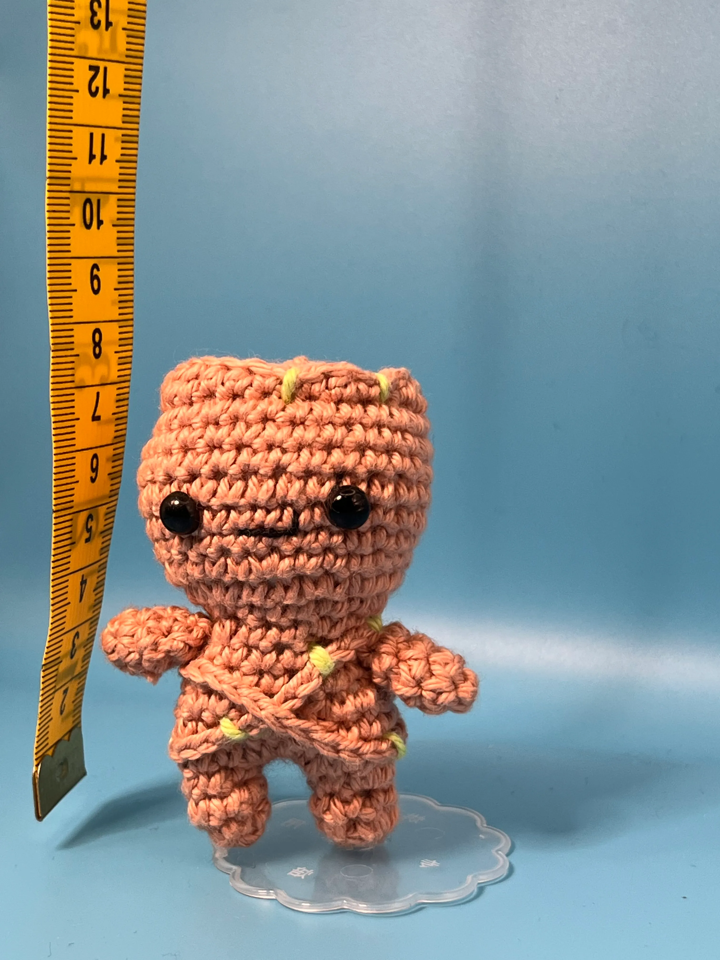 Groot amigurumi posed against a blue background