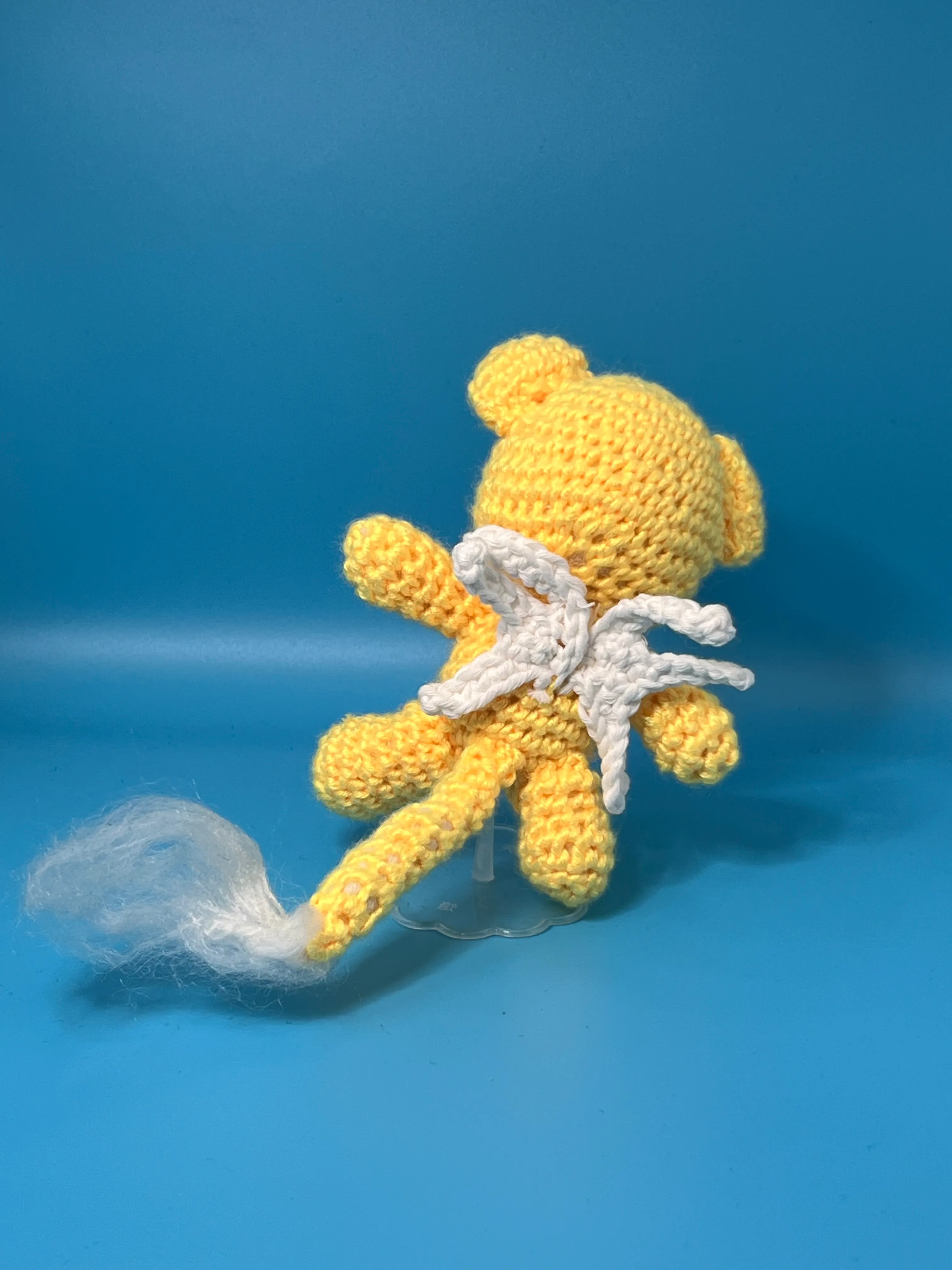 Close view of Kero’s embroidered face and long yellow ears