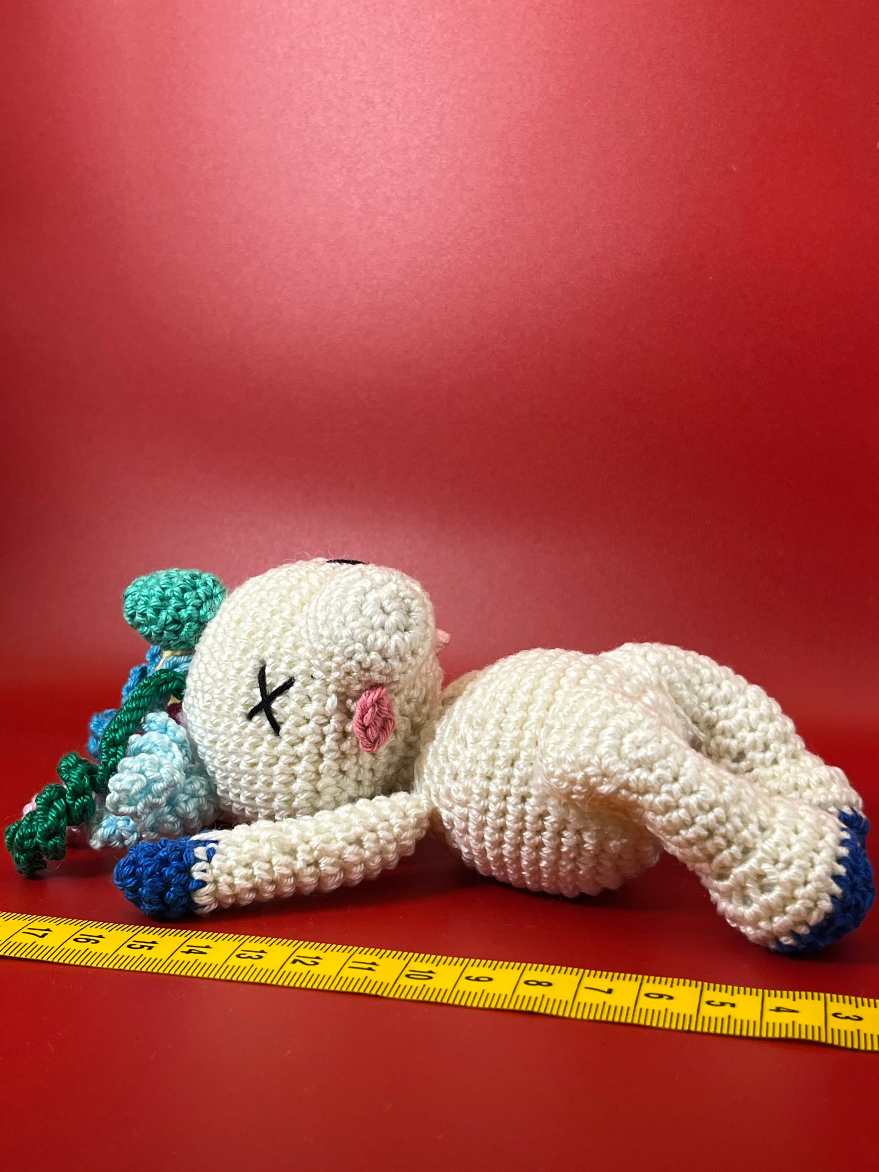 Close view of the crocheted horn and embroidered face