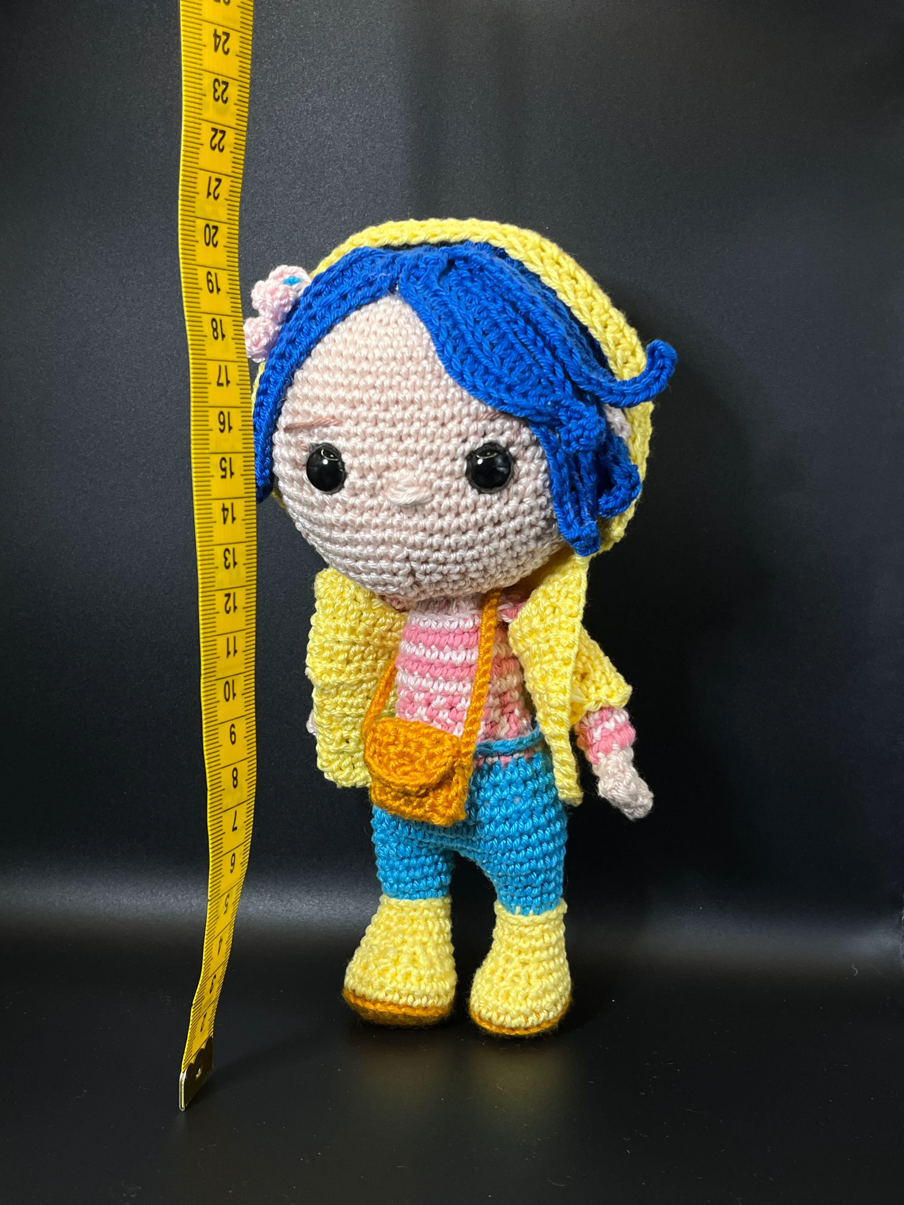 Coraline amigurumi showing her blue hair and striped shirt