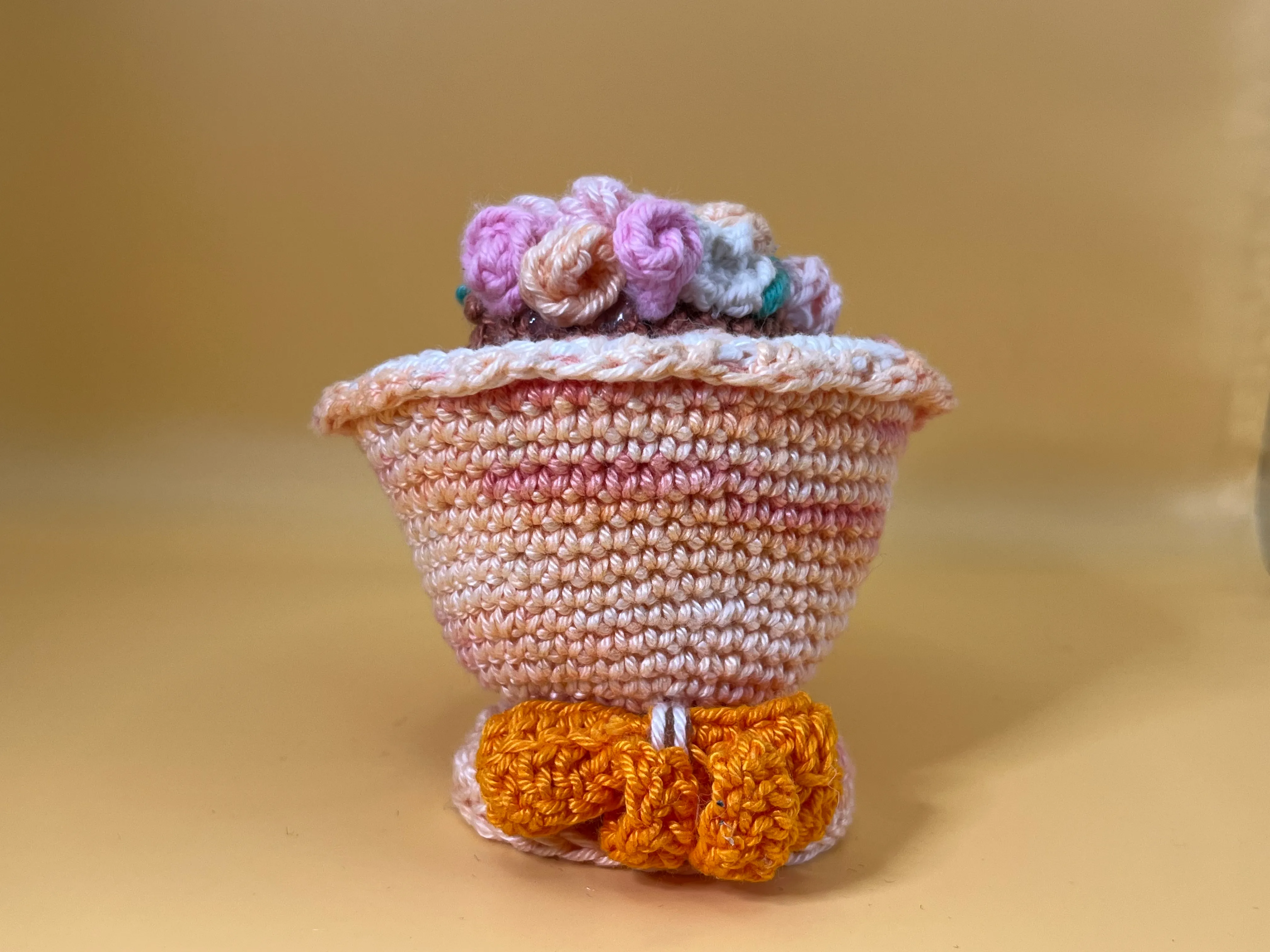 Rear view of the bridesmaid’s dress and orange crochet bow